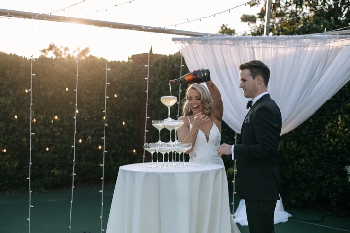 Taylor and John pouring a champagne tower