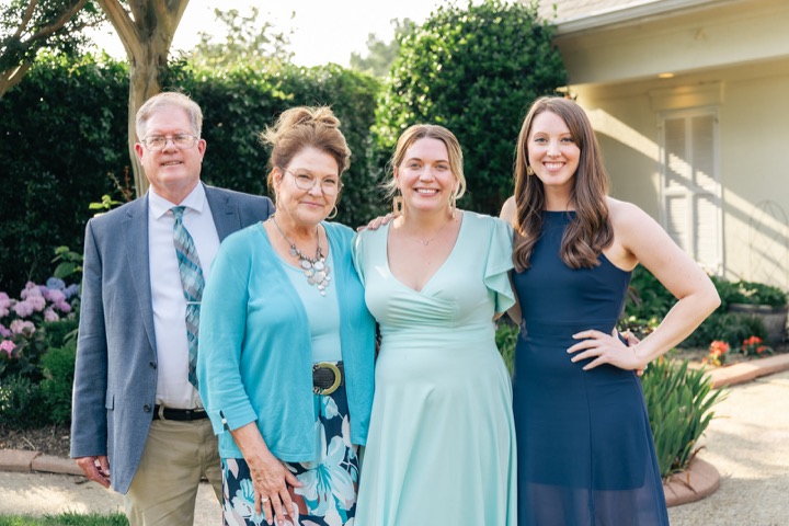 Leslie posing with family outside the Manor