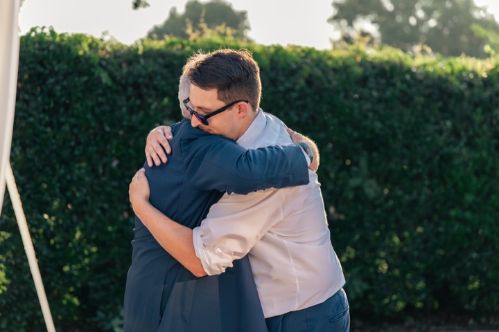 Dave embracing a guest during the celebration