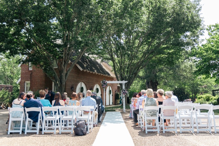 Guests gathering in the white ceremony chairs