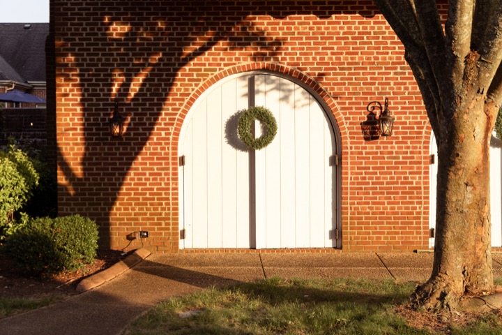 The Carriage House doors illuminated after sunset