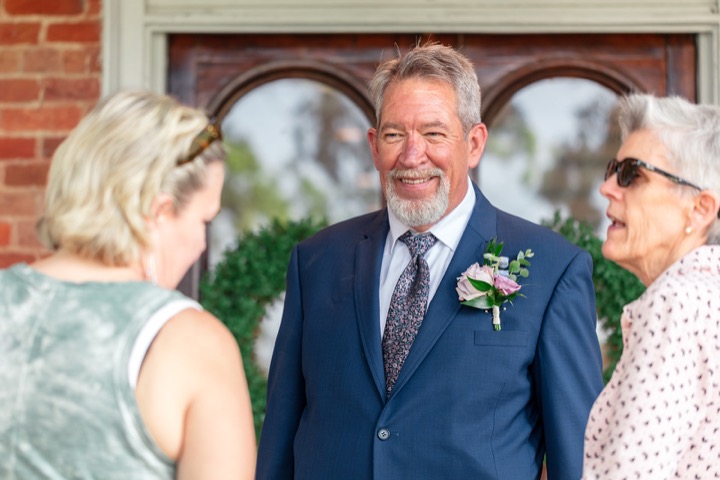 Dave talking with guests in the garden