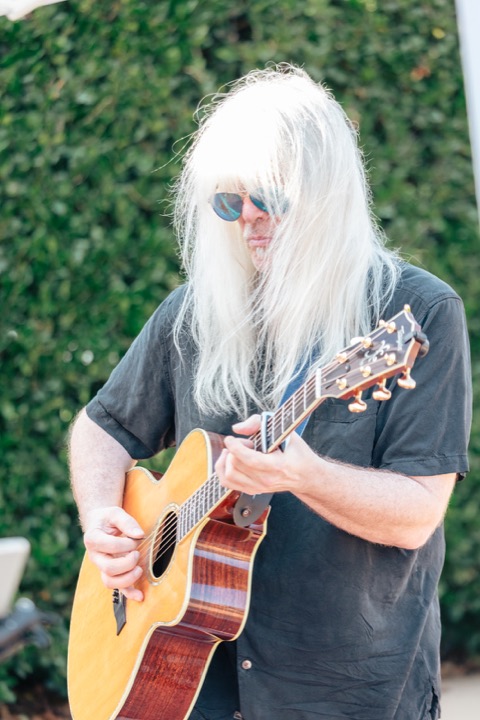 A musician playing guitar outdoors