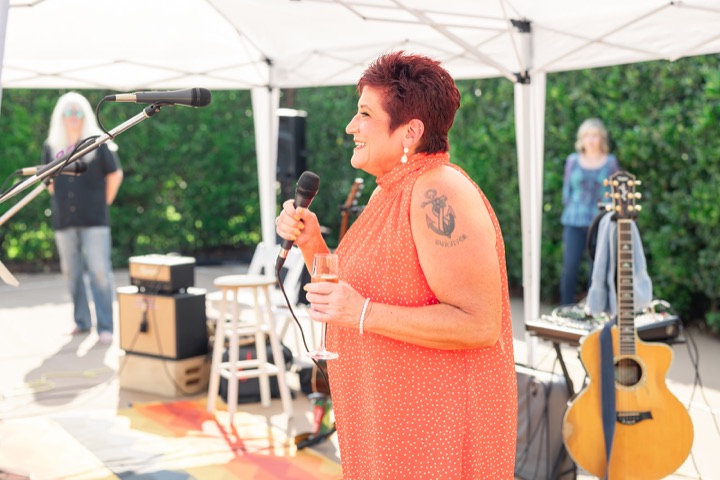 A guest speaking into a microphone during the reception