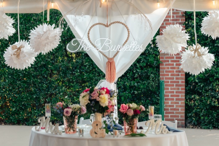 A decorated reception table framed by white drapery