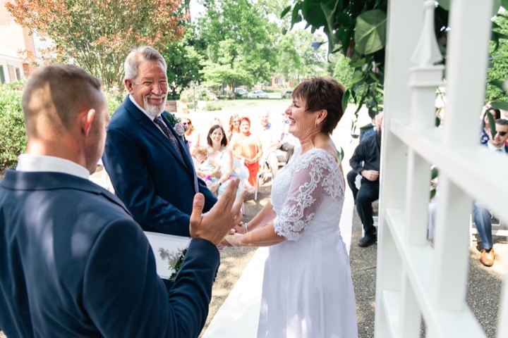 Dave and Leslie holding hands during their vows