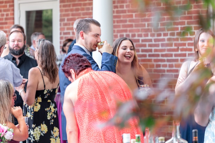 Guests sharing a conversation beside the Carriage House